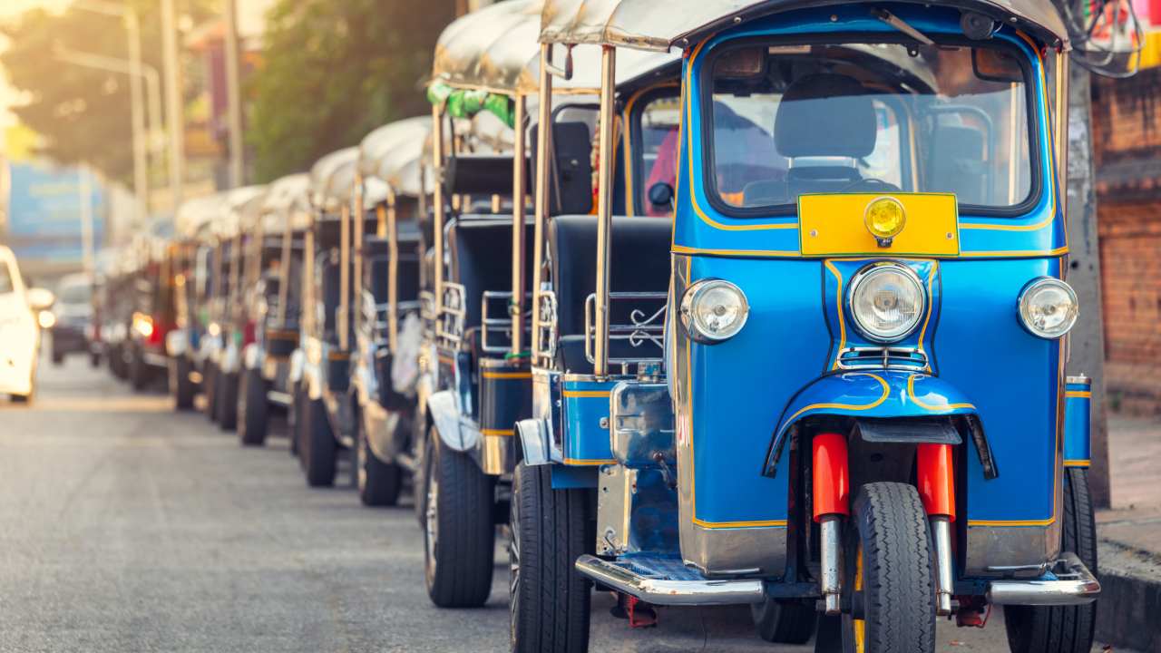 line of Tuktuks on a street in India