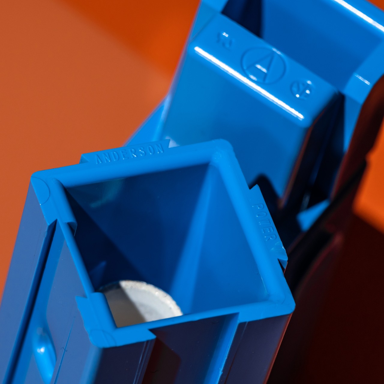 Photograph of blue Powerpole connectors on orange background